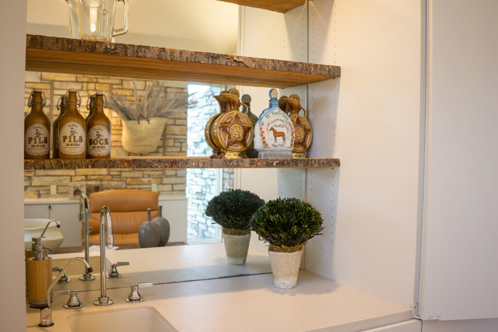 A wet bar area with a mirrored wall
