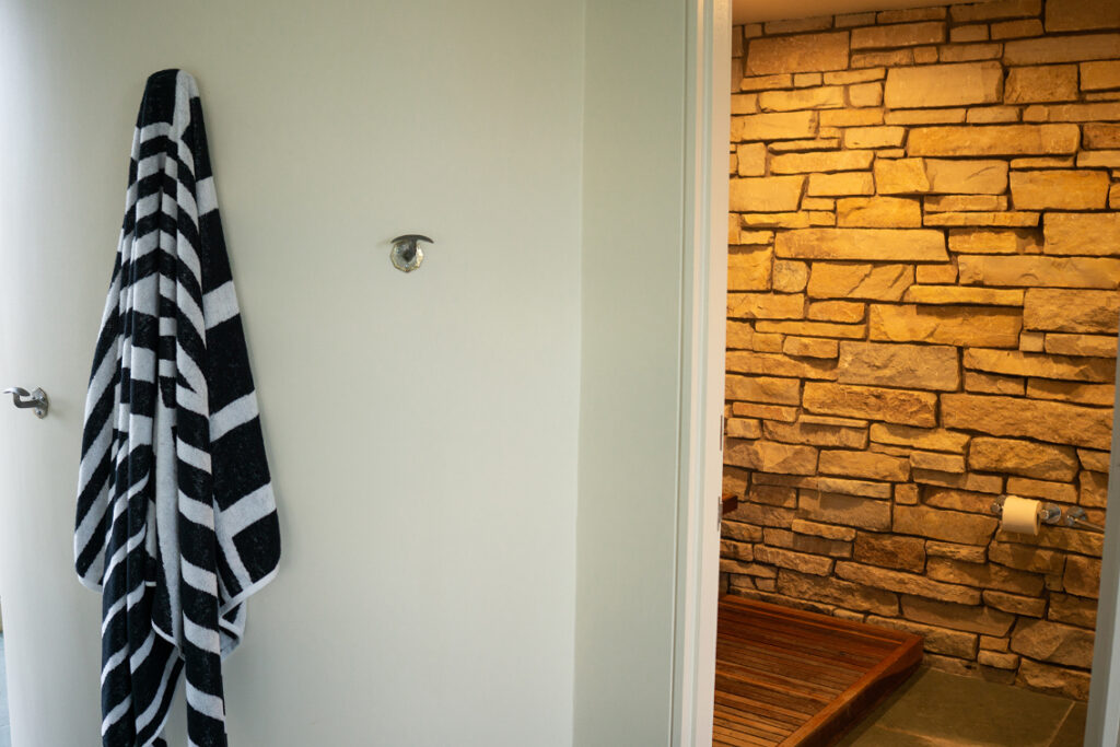 A photo of a stone wall in a powder room.