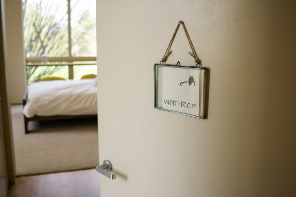 A bedroom door with a sign that says "Winthrop"